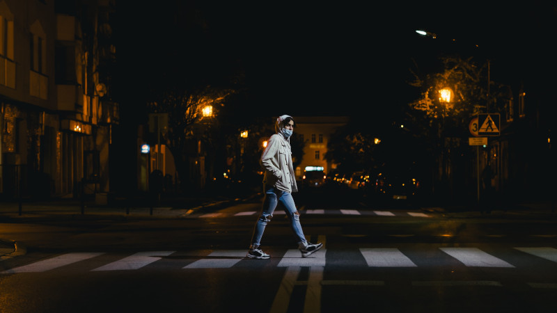 Adult walking across a pedestrian crossing